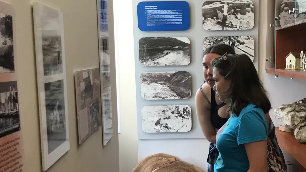 Two women viewing a display in the Mission Viejo Heritage House.