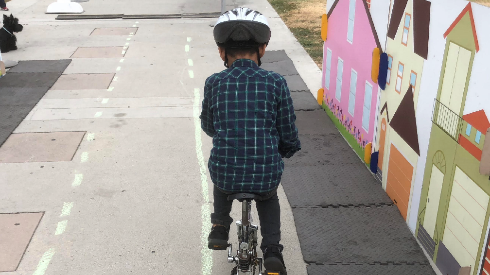 young boy riding a bike