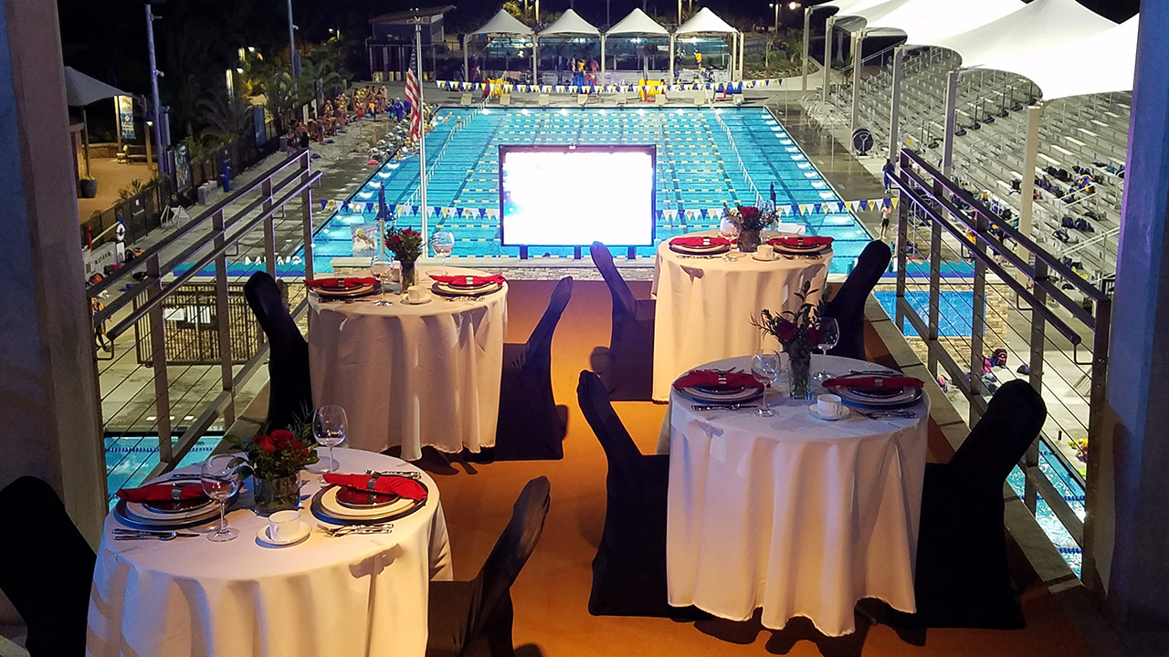 tables set up on dive tower overlooking pools