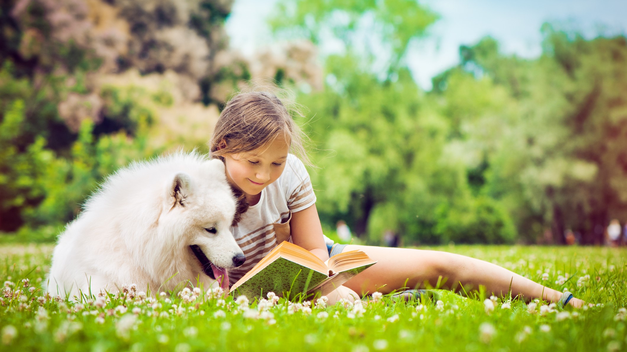 kid reading to dog