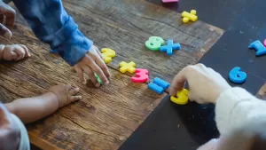 Children's hands with math tiles