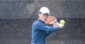 male tennis player hitting the ball