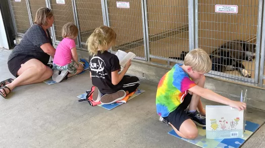 kids reading to shelter dogs