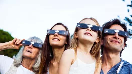 family wearing eclipse glasses