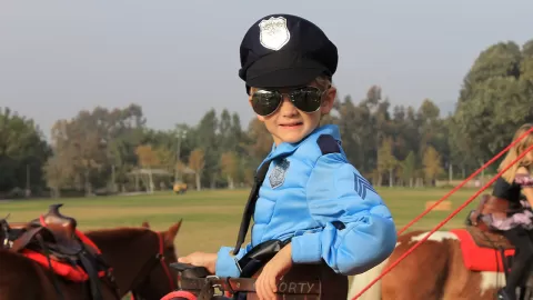 young boy in police costume