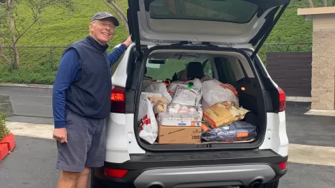 man with car full of pet donations