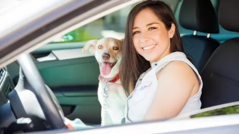 girl in car with dog