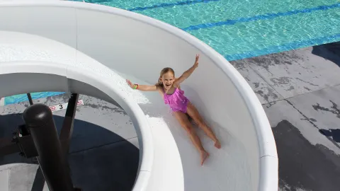 little girl going down water slide