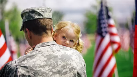 veteran holding child