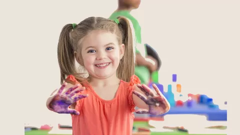 little girl playing with paint
