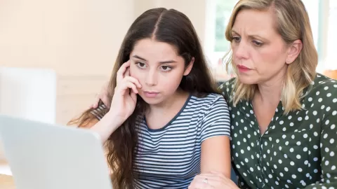 teen girl and mom on laptop