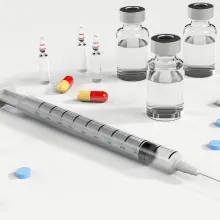 syringe, bottles and pills