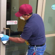 staff cleaning doors