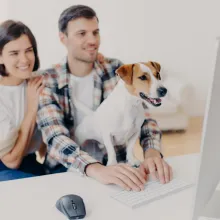 couple with dog on computer
