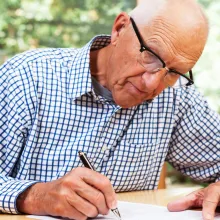 senior man filling out paperwork