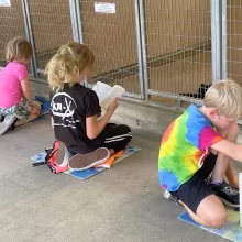 kids reading to dogs