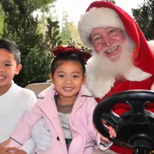 santa with kids in a golf cart