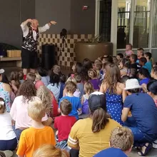 magician in front of group of kids