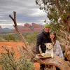couple with dog in red rock desert