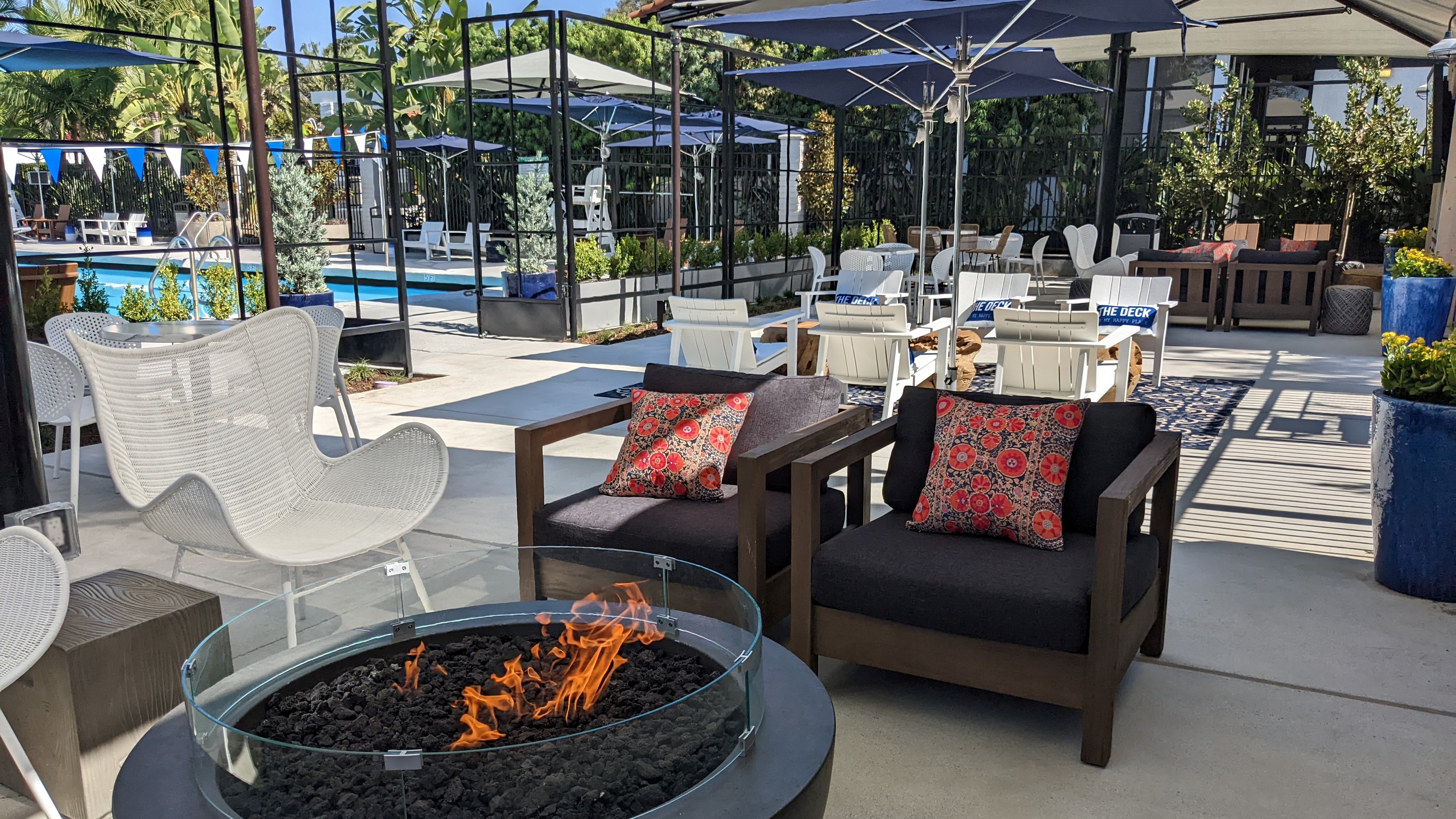 Pool deck space with chairs and fire pits