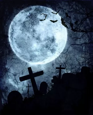 full moon hovering over cemetery